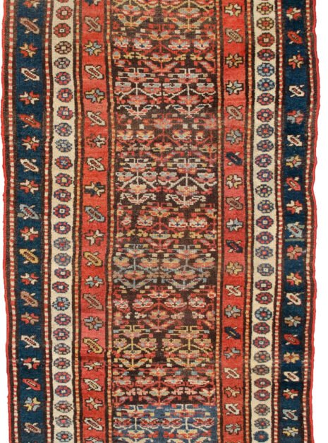 alt="Vintage Persian runner with greyish-brown ground and shrub design" alt="Hallway rug with abrash, shrub motifs, and multiple narrow borders" alt="Low-pile vintage runner with red, cream and blue accents" alt="Charming Persian hallway runner with soft colour changes"