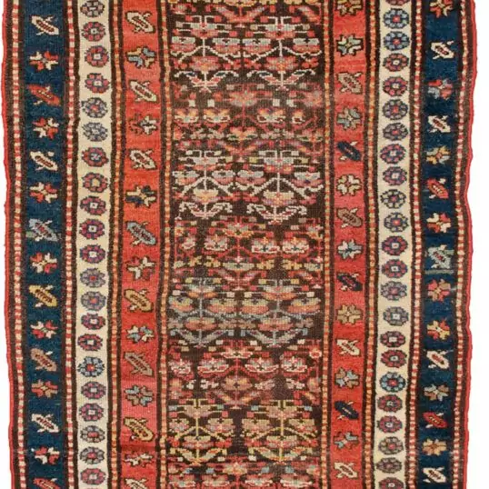 alt="Vintage Persian runner with greyish-brown ground and shrub design" alt="Hallway rug with abrash, shrub motifs, and multiple narrow borders" alt="Low-pile vintage runner with red, cream and blue accents" alt="Charming Persian hallway runner with soft colour changes"