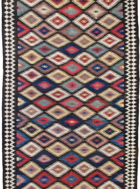 This rare and beautifully woven Saveh kilim is a testament to the exceptional quality and artistry that emerges from even the lesser-known weaving regions of Iran. While the city of Saveh and its surrounding villages are not major kilim production centres, the pieces that do originate from there are often outstanding in both design and craftsmanship—and this example is no exception. The kilim features a dazzling all-over lozenge design, bold and rhythmic, creating visual energy that draws the eye and enlivens any space. The field is framed by a soft cream border, which not only softens the dynamic central pattern but also elevates the overall composition with elegance and balance. Woven using traditional flatweave techniques and naturally dyed wool, this piece is lightweight yet durable, and easy to use in various interior settings—from rustic and eclectic to contemporary and minimalist. Kilims like this are often underrated, yet they represent a sophisticated blend of utility, tradition, and decorative appeal. This piece, in particular, stands out as an engaging and collectible work of woven art. ✅ Key Features: Origin: Saveh, Iran Type: Kilim (flatweave) Design: Dazzling lozenge pattern Border: Cream, with geometric motifs Material: Wool Dye: Natural vegetable dyes Condition: Excellent Size: (Insert dimensions if available) Use: Wall hanging, floor rug, layering textile, collector’s item ✅ Why This Kilim? Rare in origin and rich in style, this Saveh kilim brings colour, movement, and authentic craftsmanship to any interior—a true decorative gem. ✅ Call to Action Celebrate the art of flatweave with this vibrant Saveh kilim—a stylish and distinctive piece woven with heritage and flair.