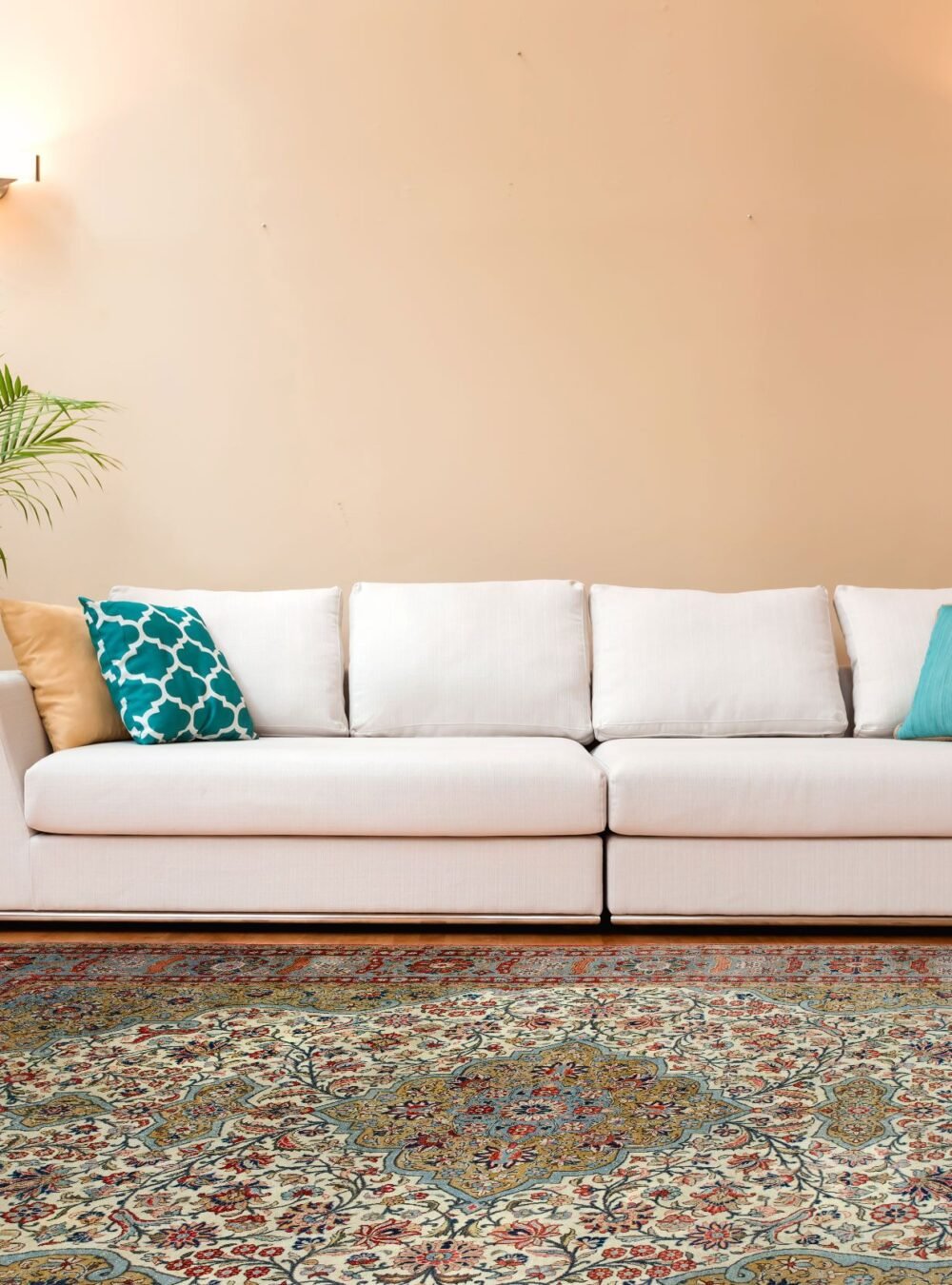 White couch in a large luxury home Antique Persian rug in a neutral London living room with mid-century decor