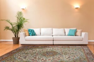 Antique Persian rug in a neutral London living room with mid-century decor