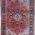 alt="Vintage Ahar Heriz carpet with red field and blue floral border" alt="Persian Heriz rug with central medallion and cream spandrels" alt="Northwest Iran rug with stylised floral design and bold medallion" alt="Traditional Heriz carpet from Ahar with red and blue color palette"