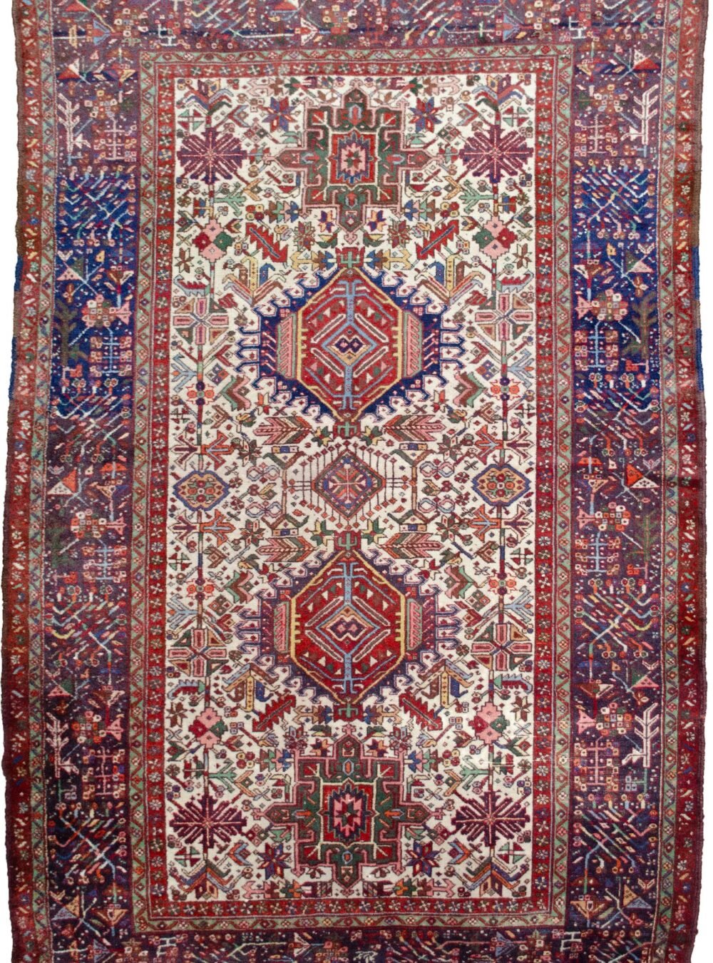 alt="Karaja rug with rare cream ground and multiple medallions" alt="Persian tribal rug with royal blue geometric border and Karaja motifs" alt="Unusual Karaja rug with hidden Serapi weave start" alt="Collector Karaja carpet with cream field and blue border"