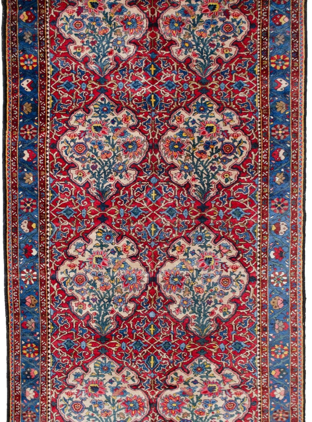 alt="Bakhtiar Faradonbeh rug with Kufic motifs and floral cartouches" alt="Persian rug with red field and cream Kufic design on cartouches" alt="Traditional Bakhtiar rug with light blue floral border" alt="Dining room Persian rug with Islamic and floral design elements"