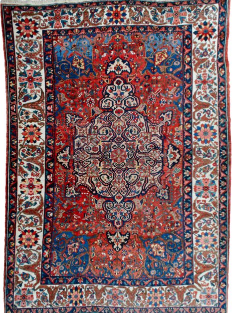 alt="Bakhtiar carpet with terracotta field, blue spandrels, and cream floral border" alt="Hand-knotted Persian rug with medallion and floral motifs from Western Iran" alt="Traditional Bakhtiar carpet with natural dye wool and central medallion design" alt="Persian wool rug featuring terracotta tones and intricate floral borders"