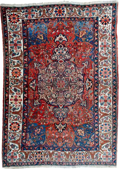 alt="Bakhtiar carpet with terracotta field, blue spandrels, and cream floral border" alt="Hand-knotted Persian rug with medallion and floral motifs from Western Iran" alt="Traditional Bakhtiar carpet with natural dye wool and central medallion design" alt="Persian wool rug featuring terracotta tones and intricate floral borders"
