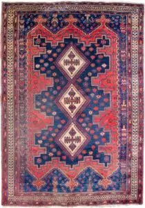 alt="Afshar Sirjan rug with triple cream medallions on blue and red field" alt="Hand-knotted Persian rug with geometric borders and tribal motifs" alt="Vintage Afshar rug with stylized bushes and blue ground medallions" alt="Wide Afshar Sirjan carpet with light wear and strong visual design"