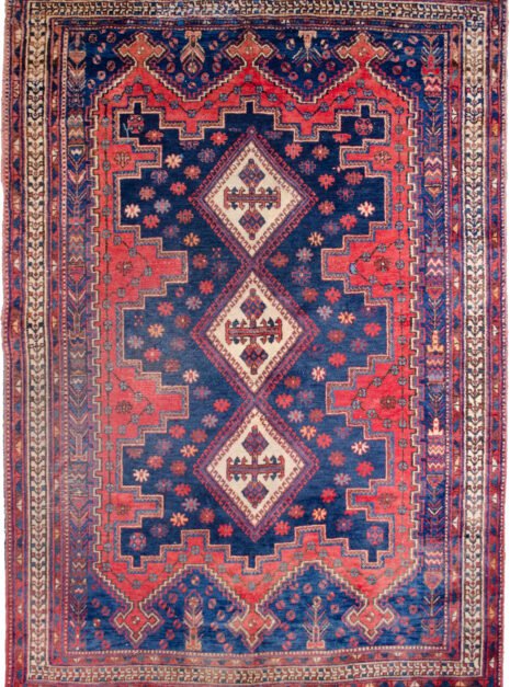 alt="Afshar Sirjan rug with triple cream medallions on blue and red field" alt="Hand-knotted Persian rug with geometric borders and tribal motifs" alt="Vintage Afshar rug with stylized bushes and blue ground medallions" alt="Wide Afshar Sirjan carpet with light wear and strong visual design"