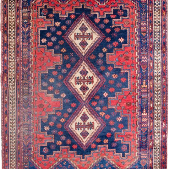 alt="Afshar Sirjan rug with triple cream medallions on blue and red field" alt="Hand-knotted Persian rug with geometric borders and tribal motifs" alt="Vintage Afshar rug with stylized bushes and blue ground medallions" alt="Wide Afshar Sirjan carpet with light wear and strong visual design"