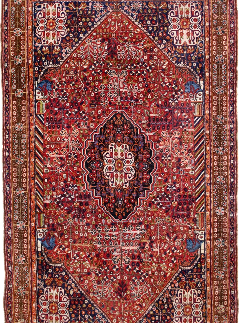 alt="Qashqai rug with deep red field, blue Hashtgol medallion, and Persepolis horse head pillars" alt="Handwoven Persian tribal rug with symbolic motifs and floral spandrels" alt="Qashqai rug featuring Hashtgol motif and paisley flower heads" alt="Decorative Persian rug with blue medallion and brown floral border"