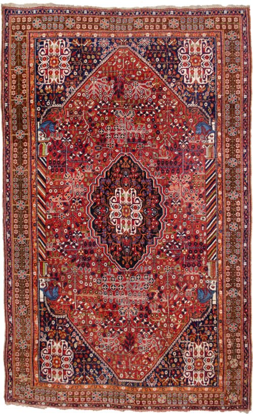 alt="Qashqai rug with deep red field, blue Hashtgol medallion, and Persepolis horse head pillars" alt="Handwoven Persian tribal rug with symbolic motifs and floral spandrels" alt="Qashqai rug featuring Hashtgol motif and paisley flower heads" alt="Decorative Persian rug with blue medallion and brown floral border"