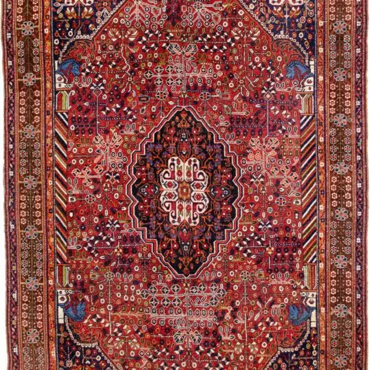 alt="Qashqai rug with deep red field, blue Hashtgol medallion, and Persepolis horse head pillars" alt="Handwoven Persian tribal rug with symbolic motifs and floral spandrels" alt="Qashqai rug featuring Hashtgol motif and paisley flower heads" alt="Decorative Persian rug with blue medallion and brown floral border"