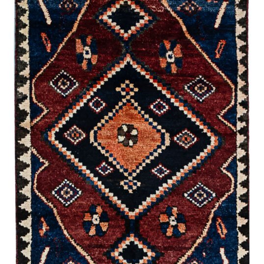 alt="Hand-knotted Bakhtiari Gabbeh rug with lozenge medallion and floral motifs" alt="Deep red Bakhtiari Gabbeh carpet with blue and orange lozenge design" alt="Persian Gabbeh rug with flower head medallion and intricate floral patterns" alt="Traditional Bakhtiari Gabbeh runner with jagged border and rich colors"