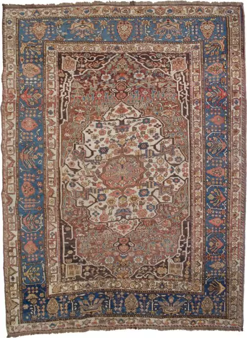 alt="Vintage Khamseh rug with cream medallion and floral motifs on reddish-brown field" alt="Persian carpet with cypress tree border and Bakhtiari-influenced design" alt="Handwoven squarish Khamseh rug with blue border and beige field" alt="Unique Persian rug with geometric guard borders and soft floral elements"