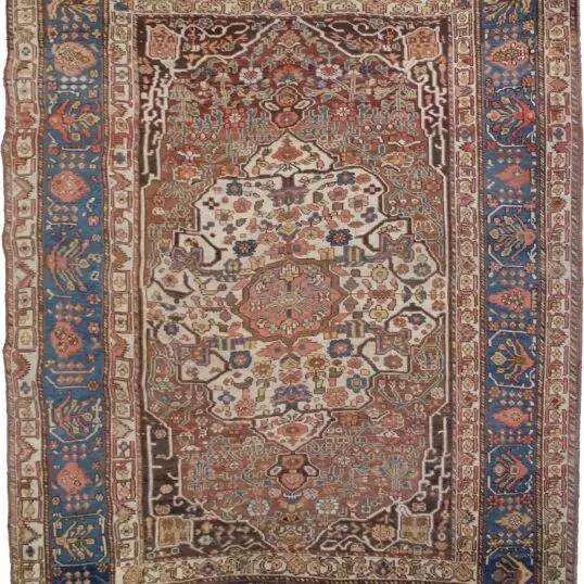 alt="Vintage Khamseh rug with cream medallion and floral motifs on reddish-brown field" alt="Persian carpet with cypress tree border and Bakhtiari-influenced design" alt="Handwoven squarish Khamseh rug with blue border and beige field" alt="Unique Persian rug with geometric guard borders and soft floral elements"