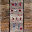 alt="Tribal Gabbeh rug with grey field and horse motif, dated 2003" alt="Stylized bush design in vintage Gabbeh with salt-and-pepper border" alt="Handwoven Iranian Gabbeh with tribal symbols and grey tones" alt="22-year-old Gabbeh rug featur