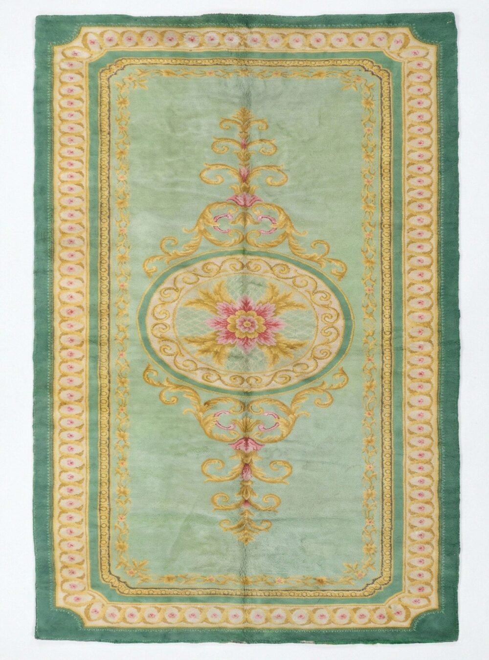 Hand-Knotted Vintage Spanish Rug M414 A full, direct overhead view of the Hand-Knotted Vintage Spanish Rug 1950s Deep Green against a white background. This shot clearly displays the 639 x 295cm dimensions, the central floral medallion, the light green field, and the thick, ornate dark green border with gold detailing.