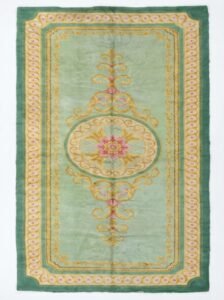 A full, direct overhead view of the Hand-Knotted Vintage Spanish Rug 1950s Deep Green against a white background. This shot clearly displays the 639 x 295cm dimensions, the central floral medallion, the light green field, and the thick, ornate dark green border with gold detailing.