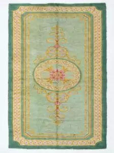 A full, direct overhead view of the Hand-Knotted Vintage Spanish Rug 1950s Deep Green against a white background. This shot clearly displays the 639 x 295cm dimensions, the central floral medallion, the light green field, and the thick, ornate dark green border with gold detailing.